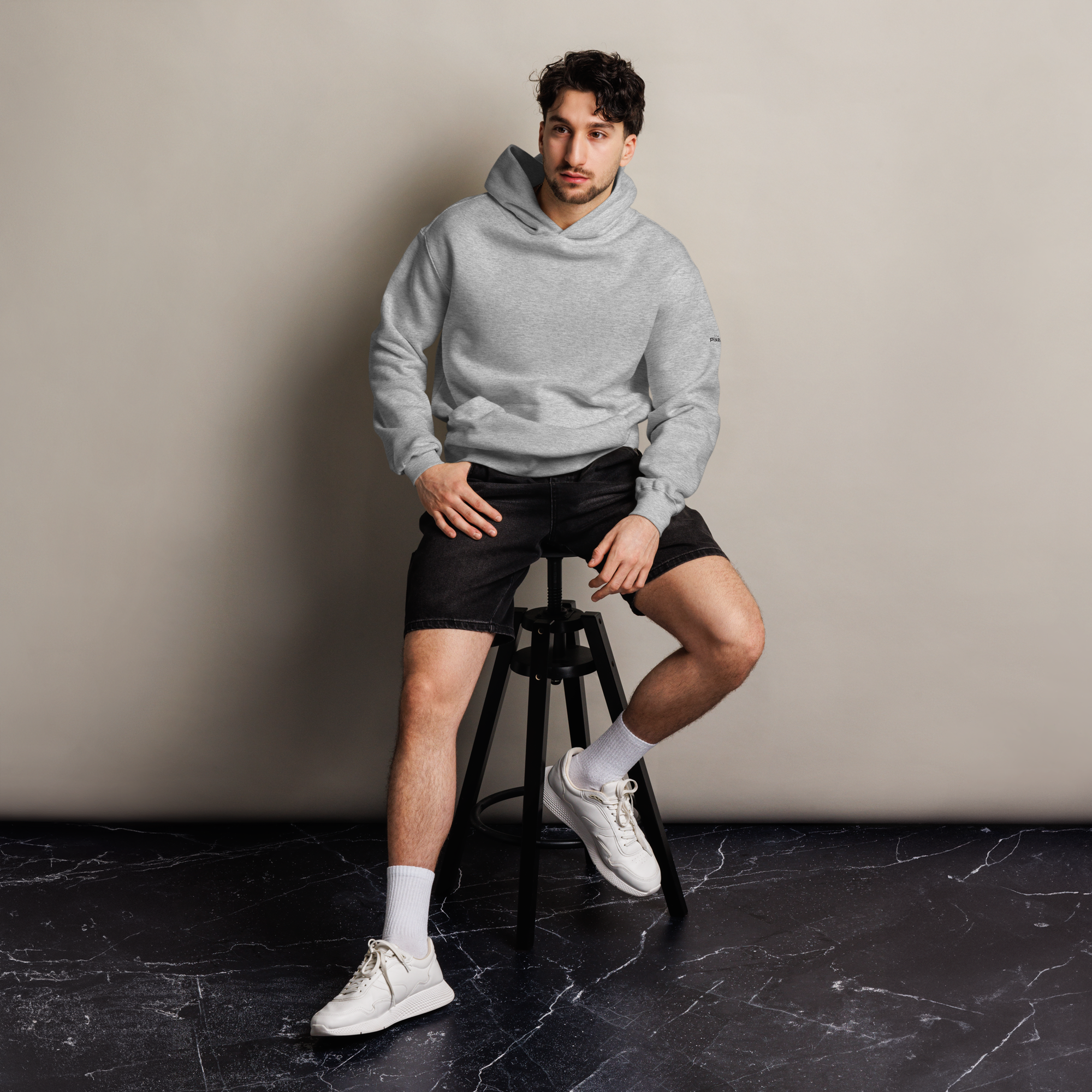 Athletic Heather oversized hoodie editorial lifestyle worn by model sitting – The Pixel Wolf