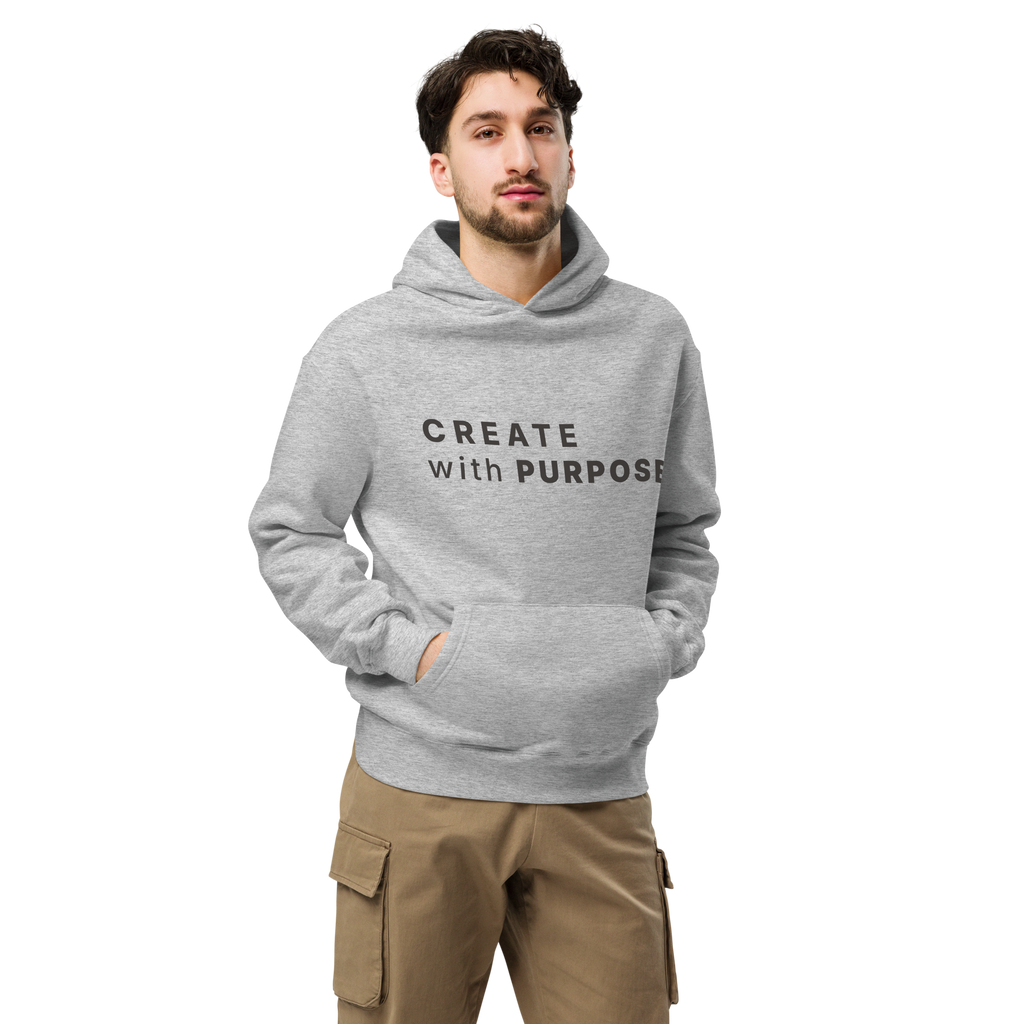 Athletic Heather oversized hoodie worn by man, oversized silhouette with “CREATE with PURPOSE” print