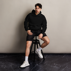 Black oversized hoodie editorial lifestyle worn by model sitting – The Pixel Wolf