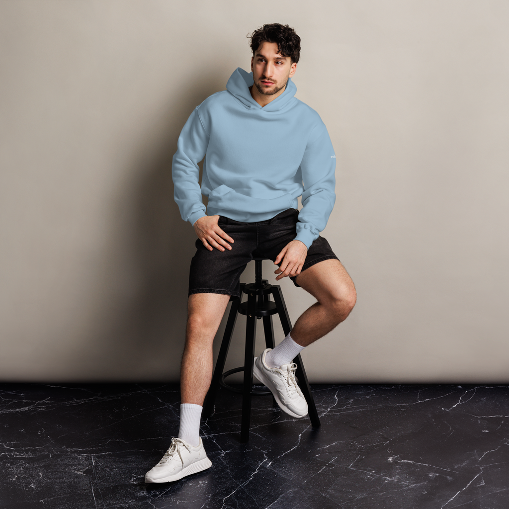 Carolina Blue oversized hoodie editorial lifestyle worn by model sitting – The Pixel Wolf