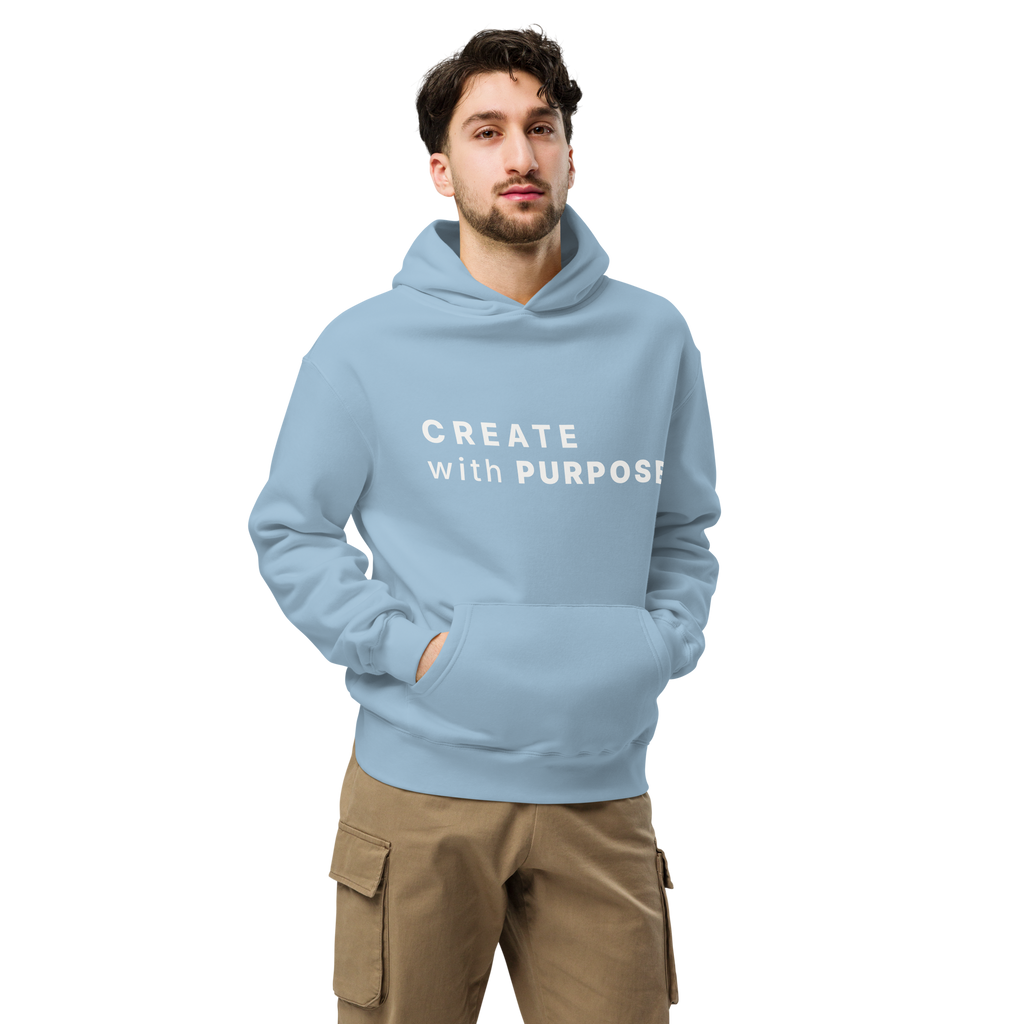 Carolina Blue oversized hoodie worn by man, oversized silhouette with “CREATE with PURPOSE” print