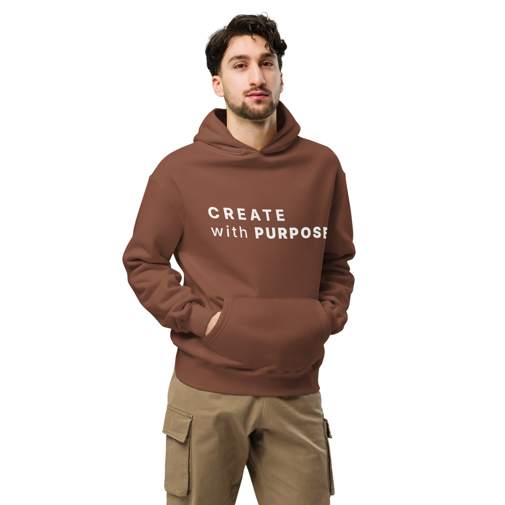 Chestnut oversized hoodie worn by man, oversized silhouette with “CREATE with PURPOSE” print