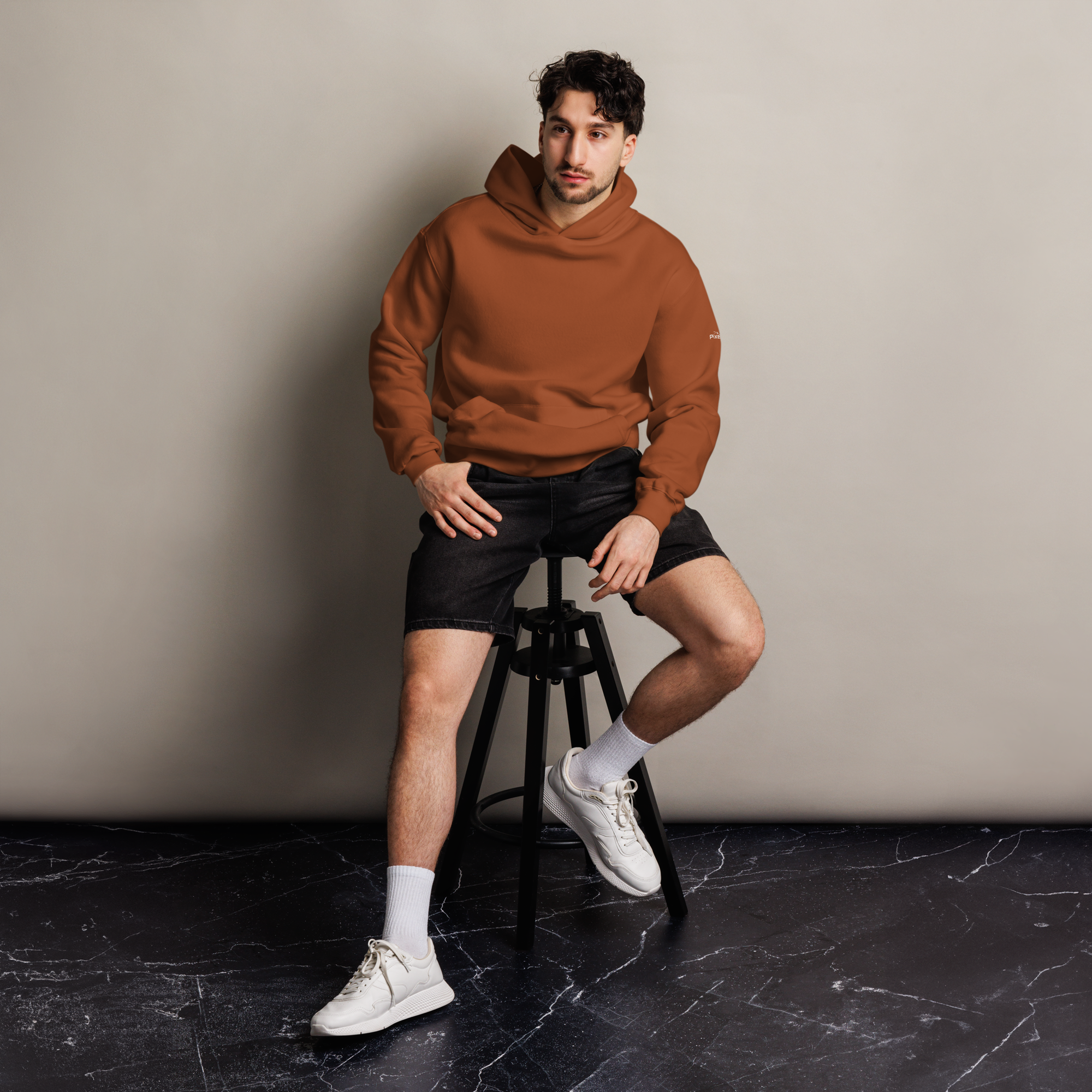 Clay oversized hoodie editorial lifestyle worn by model sitting – The Pixel Wolf