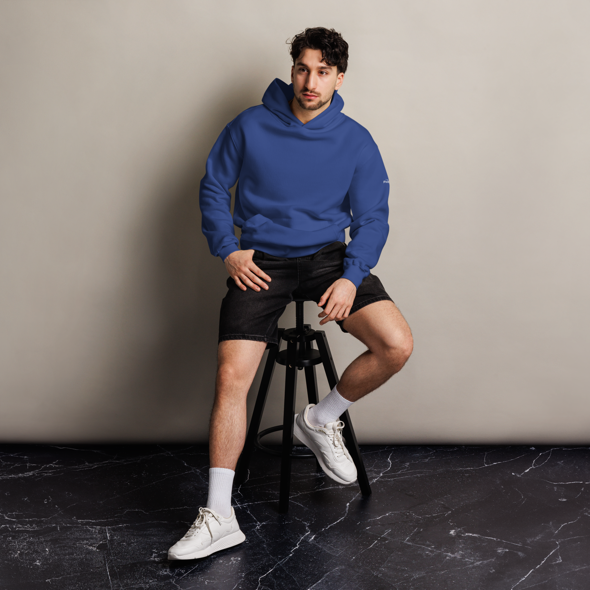 Cobalt oversized hoodie editorial lifestyle worn by model sitting – The Pixel Wolf