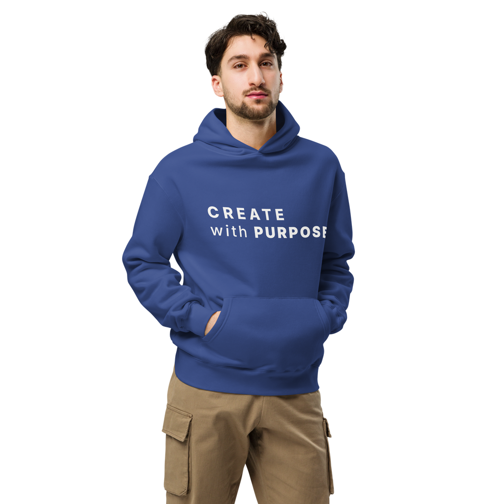 Cobalt oversized hoodie worn by man, oversized silhouette with “CREATE with PURPOSE” print