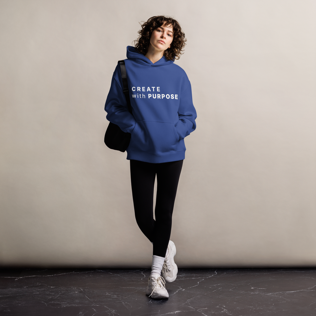 Cobalt oversized hoodie worn by woman, relaxed streetwear fit with “CREATE with PURPOSE” print