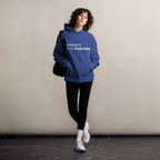 Cobalt oversized hoodie worn by woman, relaxed streetwear fit with “CREATE with PURPOSE” print