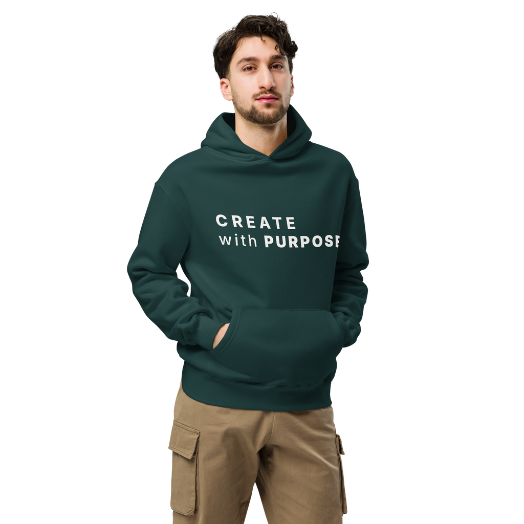 Pine Green oversized hoodie worn by man, oversized silhouette with “CREATE with PURPOSE” print