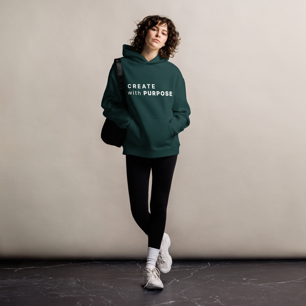 Pine Green oversized hoodie worn by woman, relaxed streetwear fit with “CREATE with PURPOSE” print