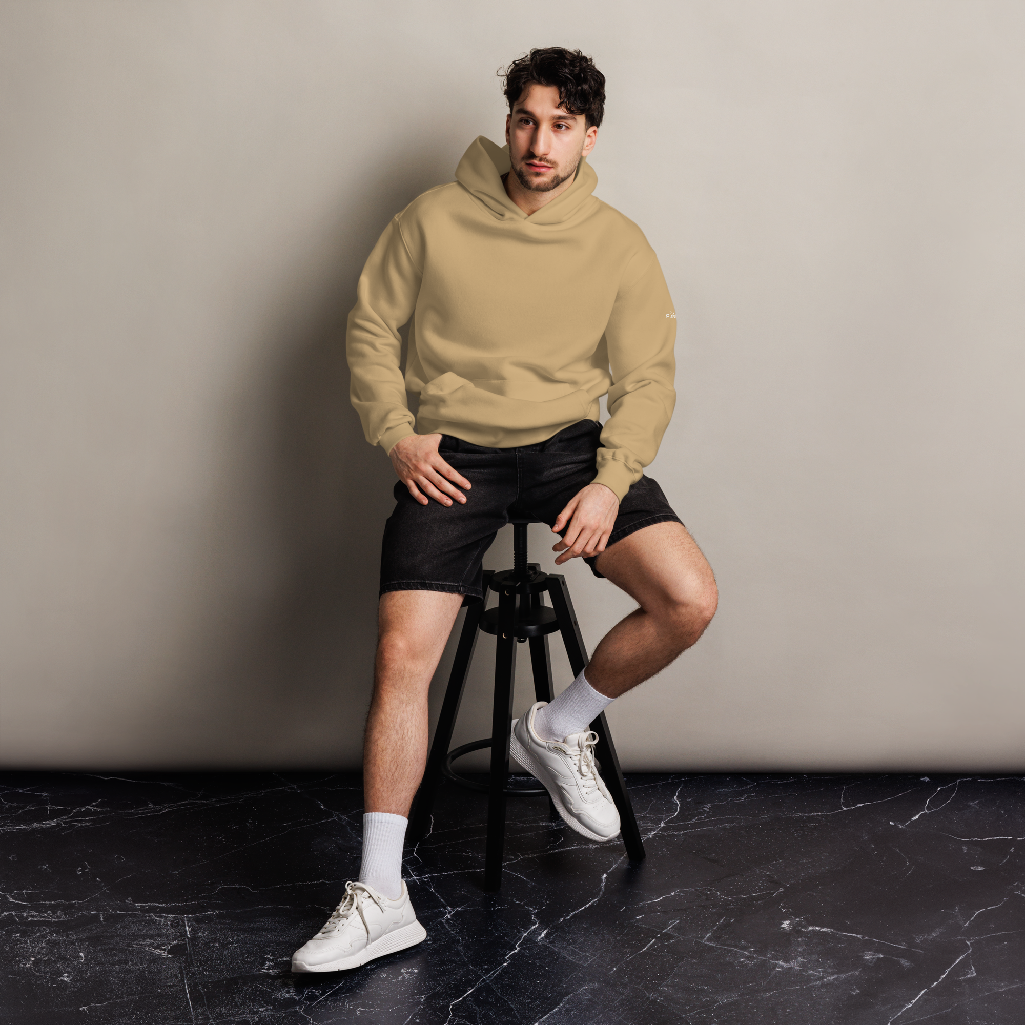 Sand oversized hoodie editorial lifestyle worn by model sitting – The Pixel Wolf