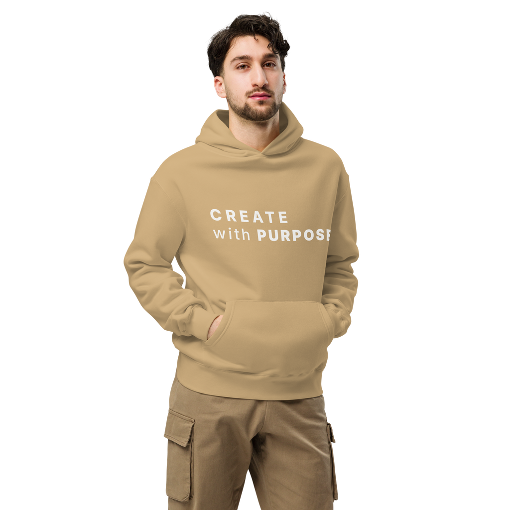 Sand oversized hoodie worn by man, oversized silhouette with “CREATE with PURPOSE” print