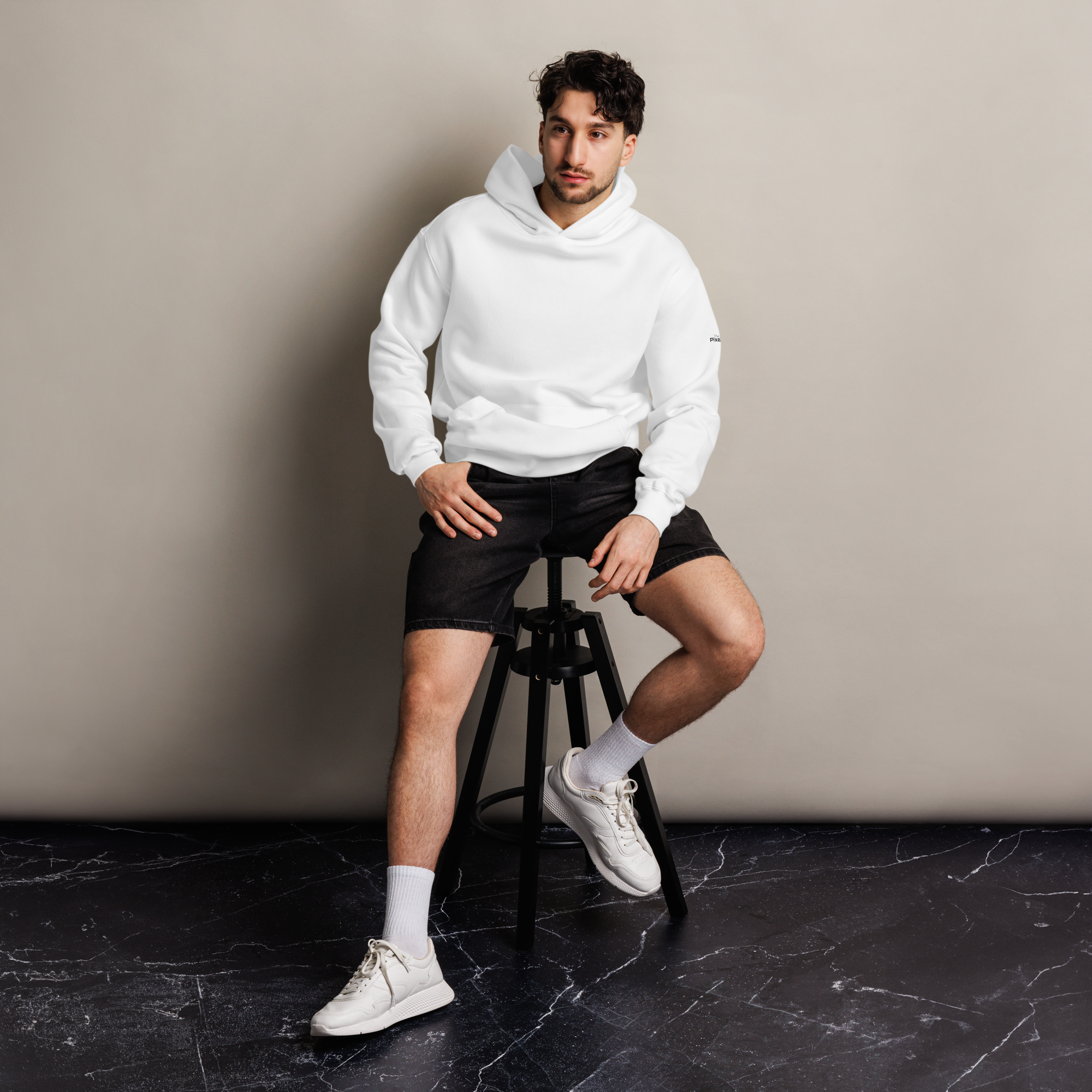 White oversized hoodie editorial lifestyle worn by model sitting – The Pixel Wolf