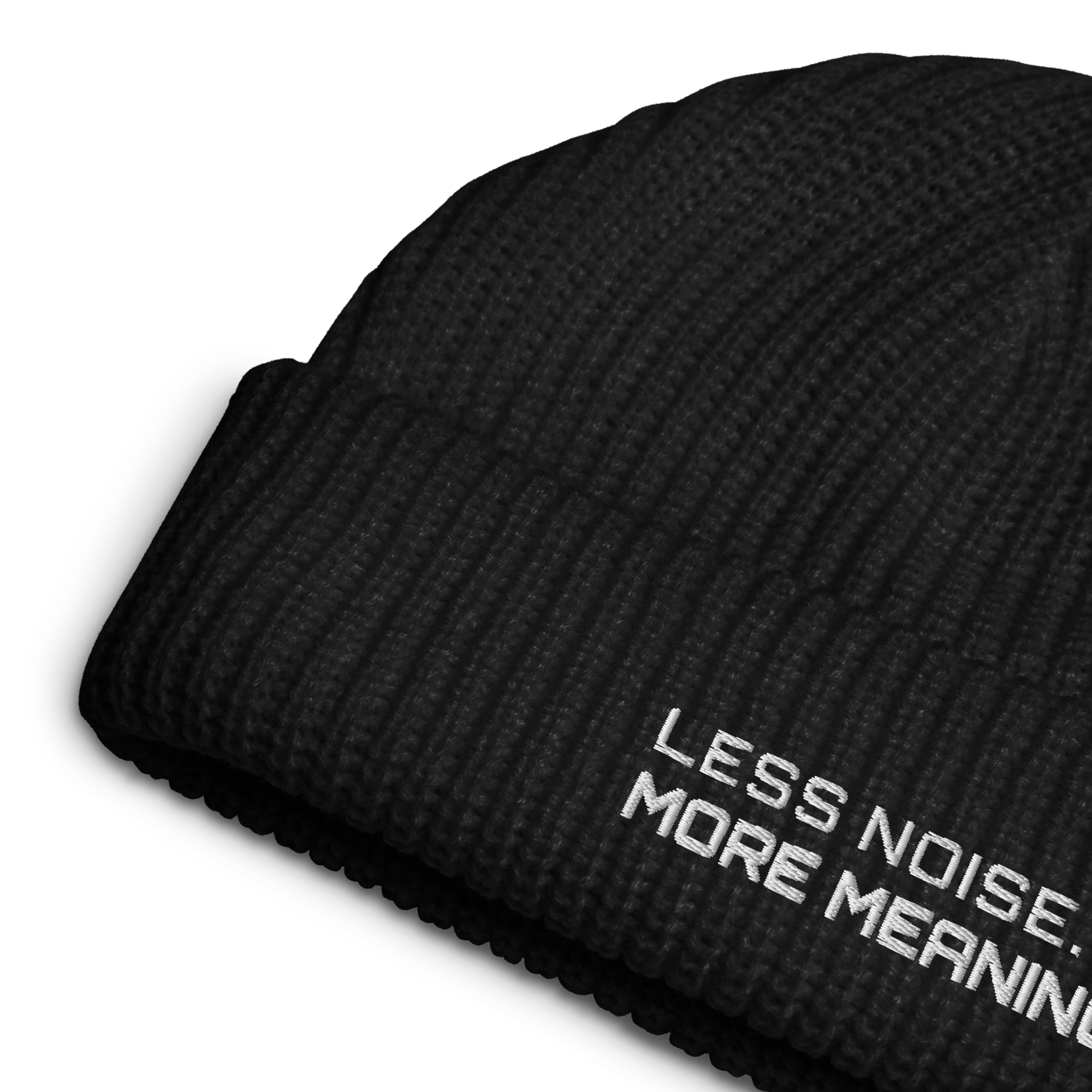 Black fisherman beanie close-up showing embroidered Less Noise More Meaning slogan