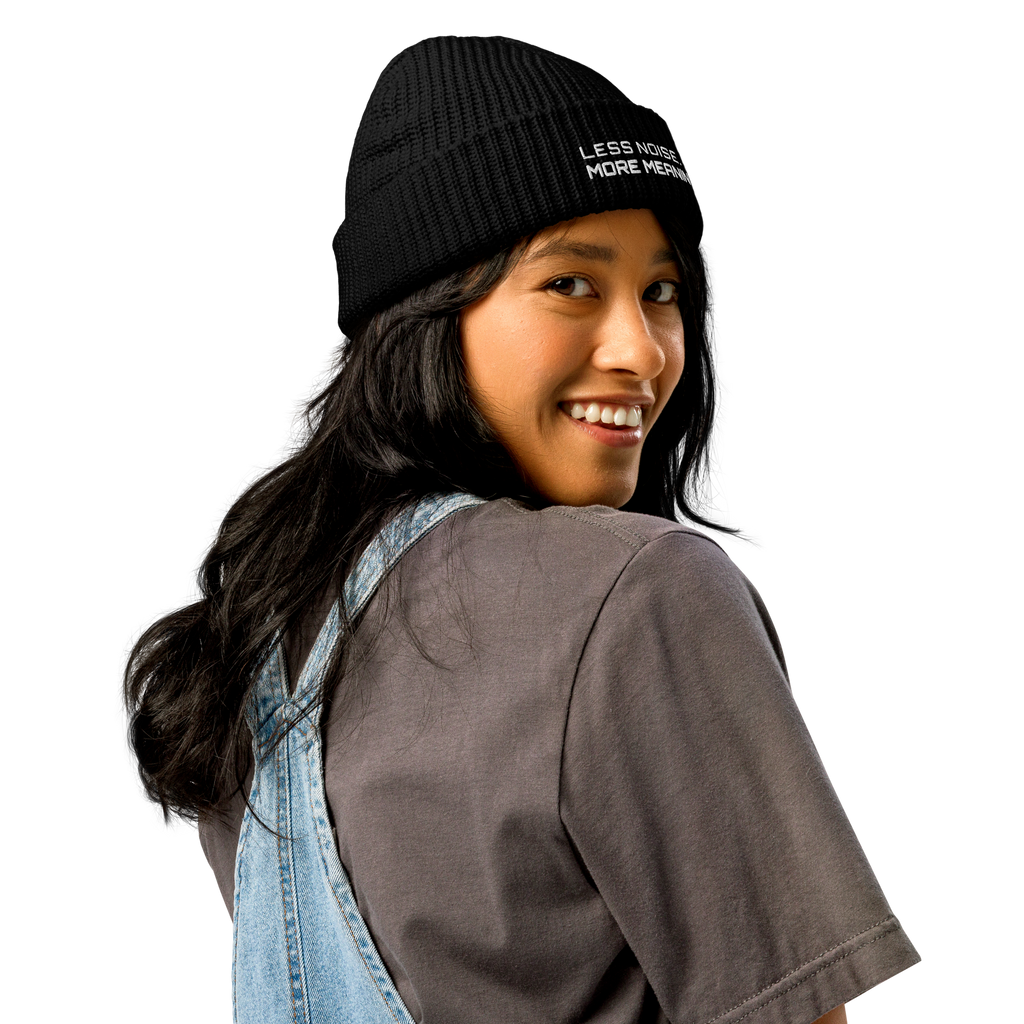 Black fisherman beanie worn in lifestyle setting with minimalist outfit