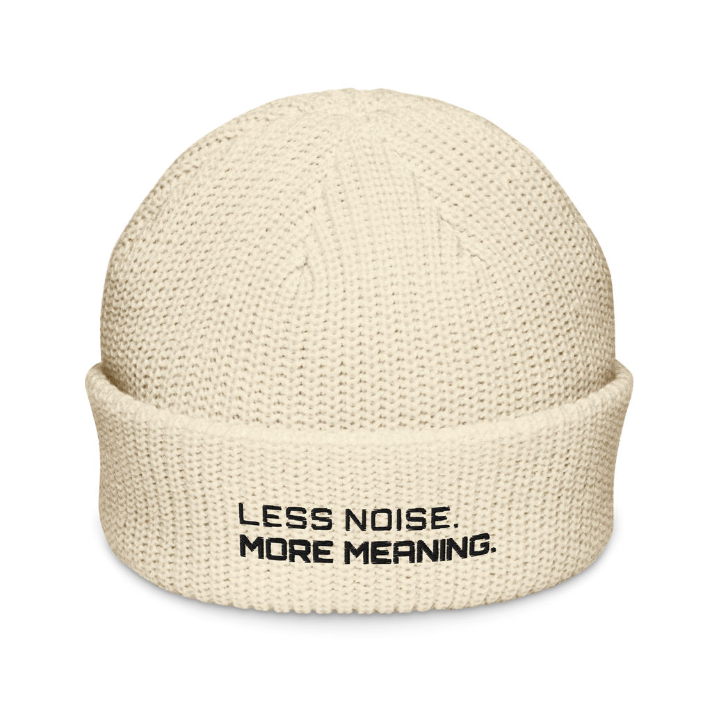 Ecru fisherman beanie front view with Less Noise More Meaning embroidery