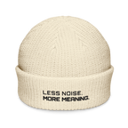 Ecru fisherman beanie front view with Less Noise More Meaning embroidery