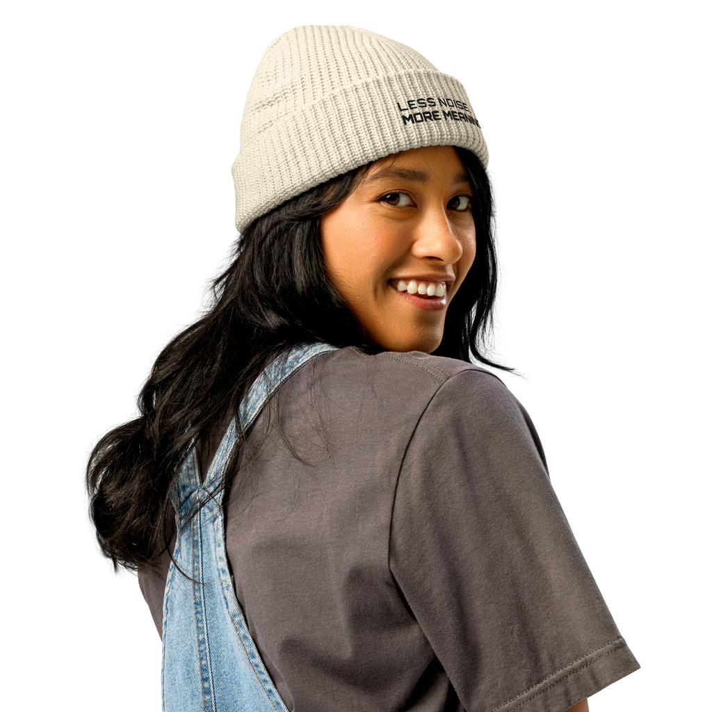 Ecru fisherman beanie worn in lifestyle setting with minimalist outfit