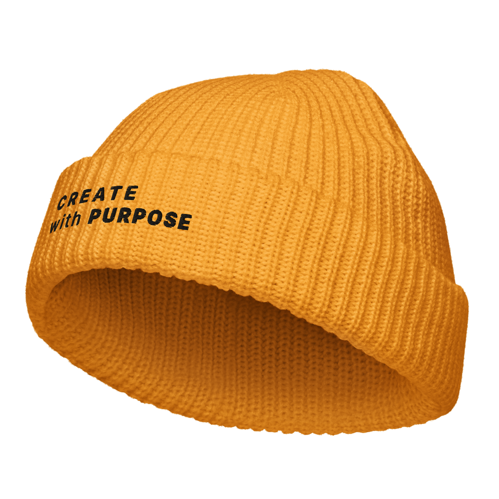 Gold fisherman beanie angled view with “CREATE WITH PURPOSE” embroidery – The Pixel Wolf