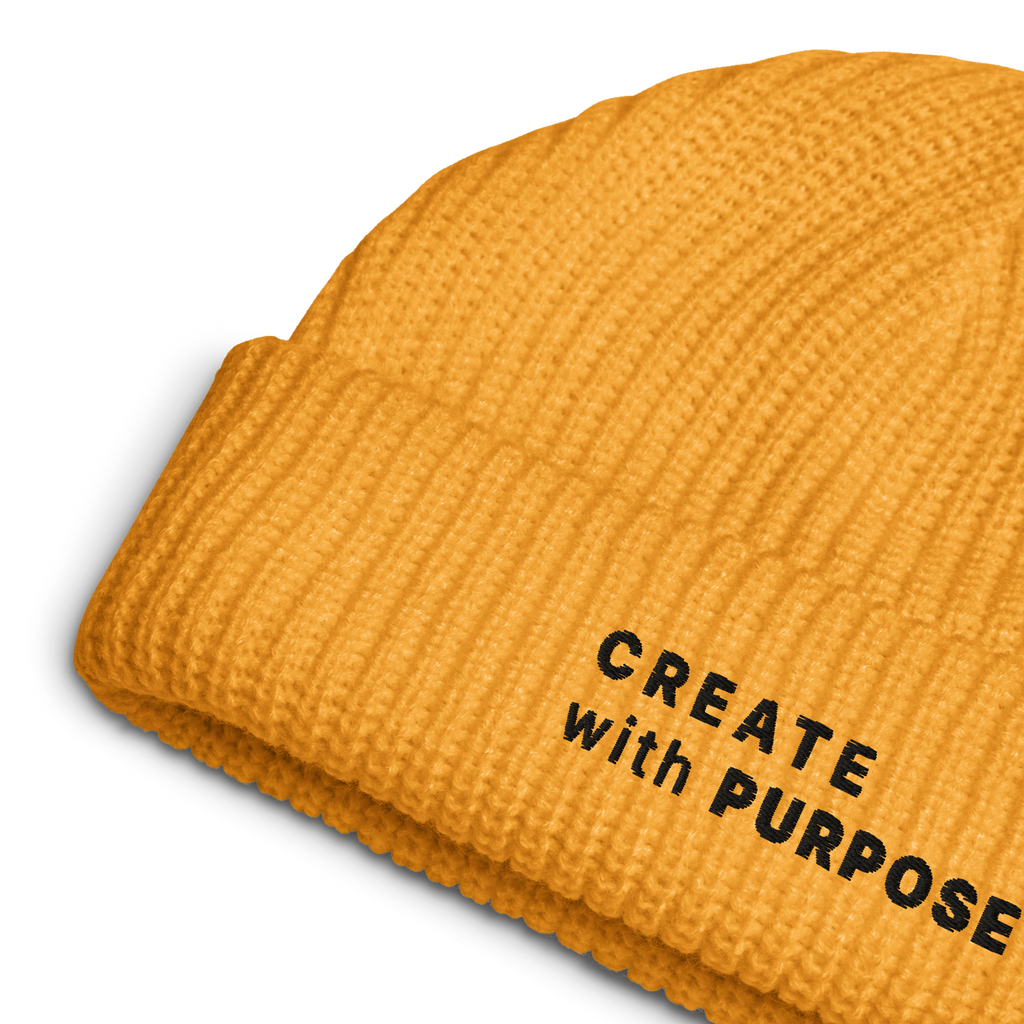 Gold ribbed knit fisherman beanie detail showing “CREATE WITH PURPOSE” embroidery – The Pixel Wolf