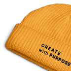 Gold ribbed knit fisherman beanie detail showing “CREATE WITH PURPOSE” embroidery – The Pixel Wolf