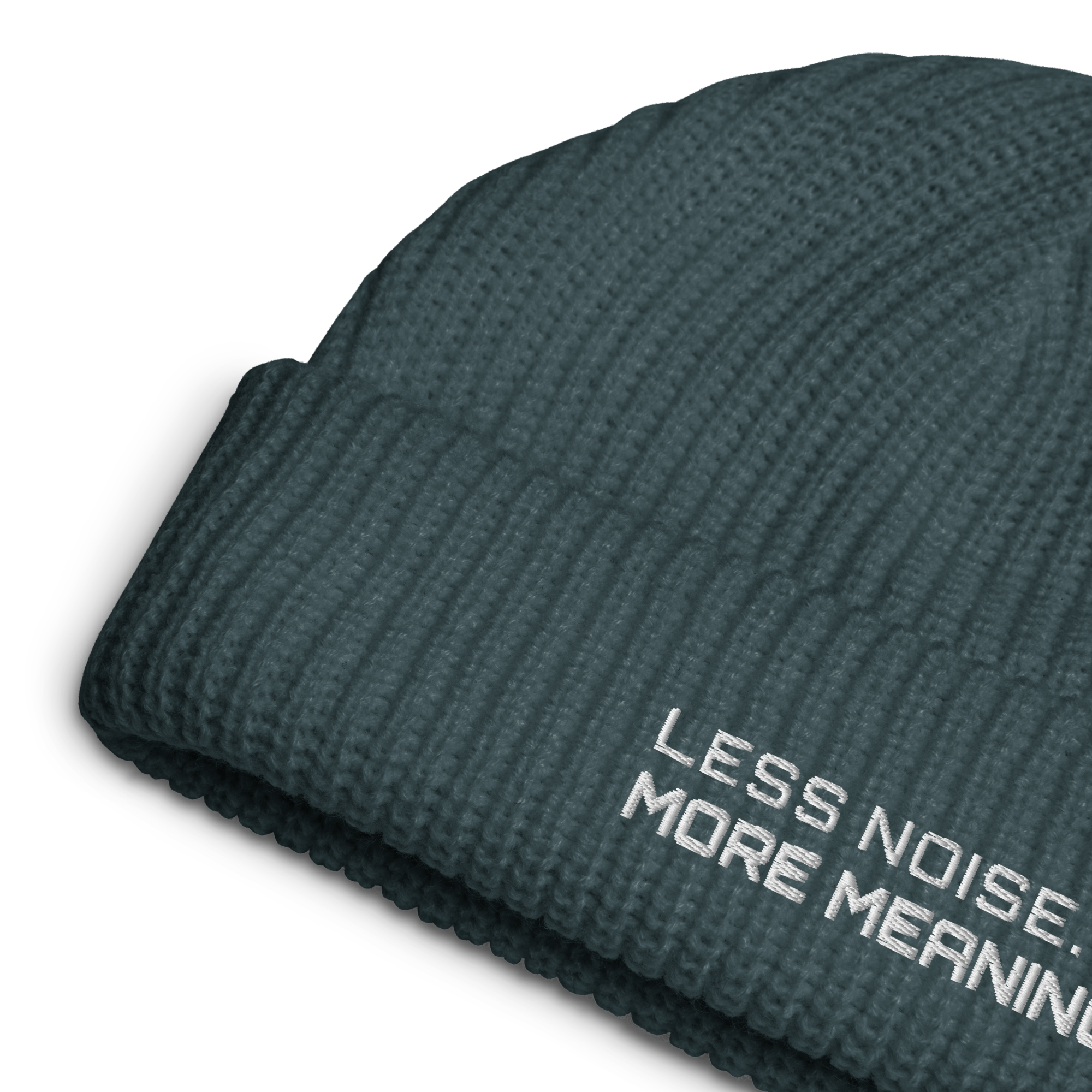 Petrol Blue fisherman beanie close-up showing embroidered Less Noise More Meaning slogan