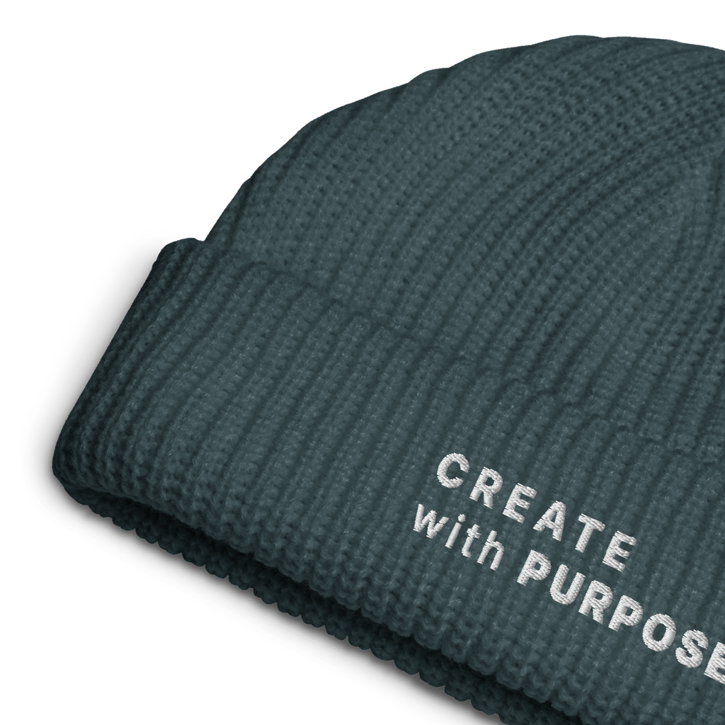 Petrol Blue ribbed knit fisherman beanie detail showing “CREATE WITH PURPOSE” embroidery – The Pixel Wolf