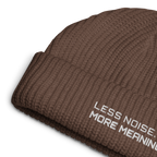 Walnut fisherman beanie close-up showing embroidered Less Noise More Meaning slogan