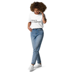 White organic cotton t-shirt lifestyle photo of woman wearing “CREATE with PURPOSE”